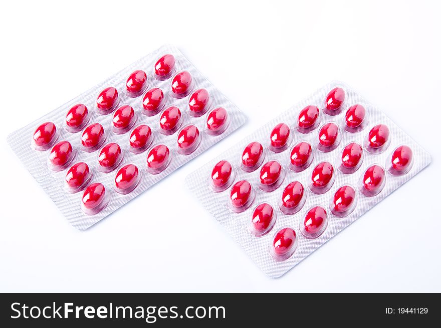 Packaging of medicine capsules red on white background. Packaging of medicine capsules red on white background