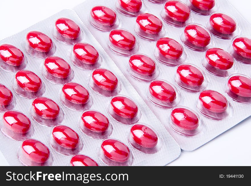 Packaging of medicine capsules red on white background. Packaging of medicine capsules red on white background