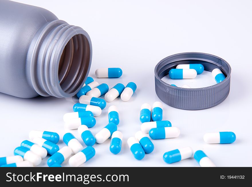 blue and white capsules of the medicament in open plastic packaging. blue and white capsules of the medicament in open plastic packaging