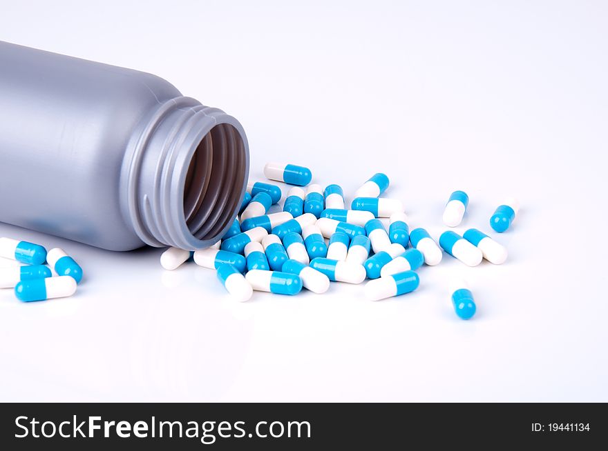Plastic container with the medicament in capsules blue and white. Plastic container with the medicament in capsules blue and white