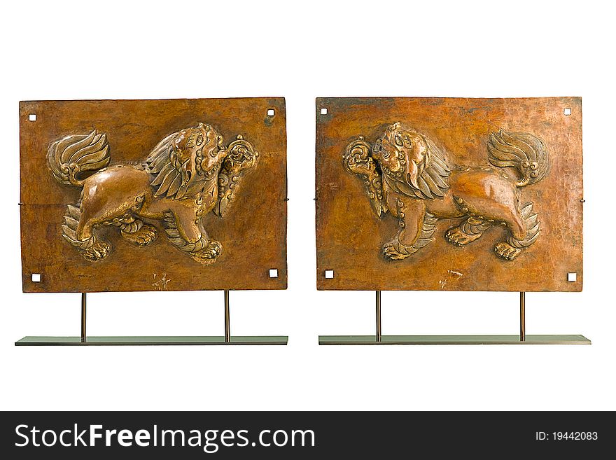 The old lions Tibetan sculpture brass works with religion history an image isolated on white . The old lions Tibetan sculpture brass works with religion history an image isolated on white