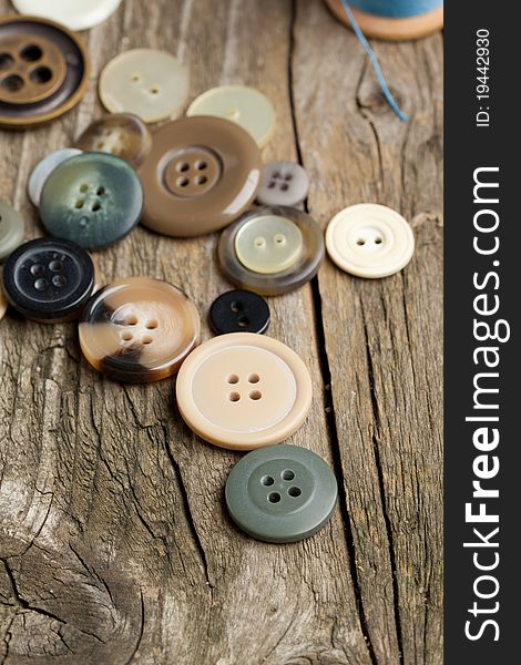 Collection of various buttons on old wooden table