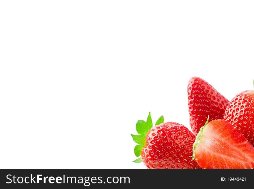 Delicious strawberries on green leaves on white isolated background