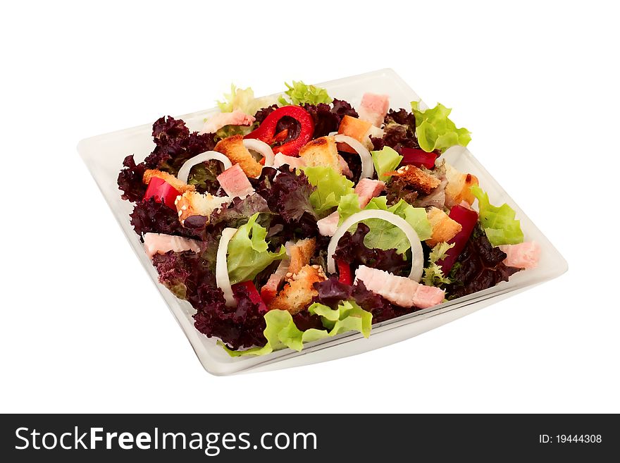 Salad of fresh vegetables, crackers and bacon over white