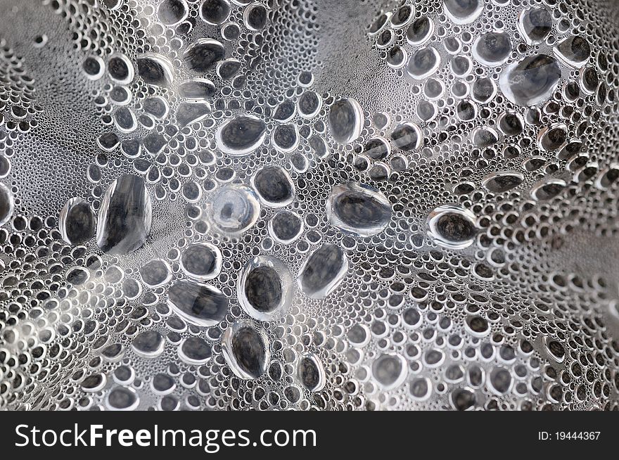 Abstract background from the drops of dew on the glass