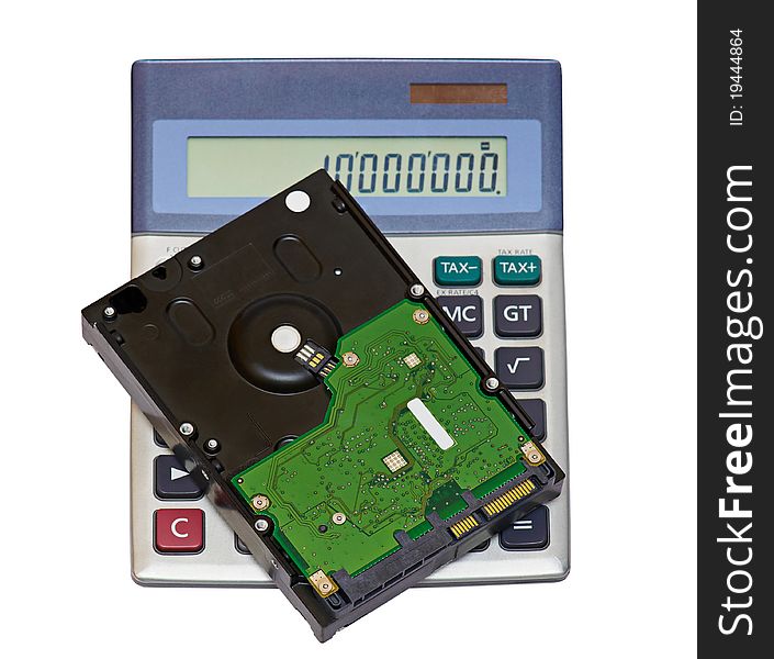 Hard disk lying on the calculator are isolated on the white. Hard disk lying on the calculator are isolated on the white