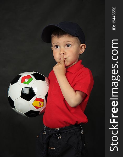 Portrait of the boy with a football on black