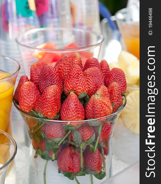 Few strawberries in glass cup