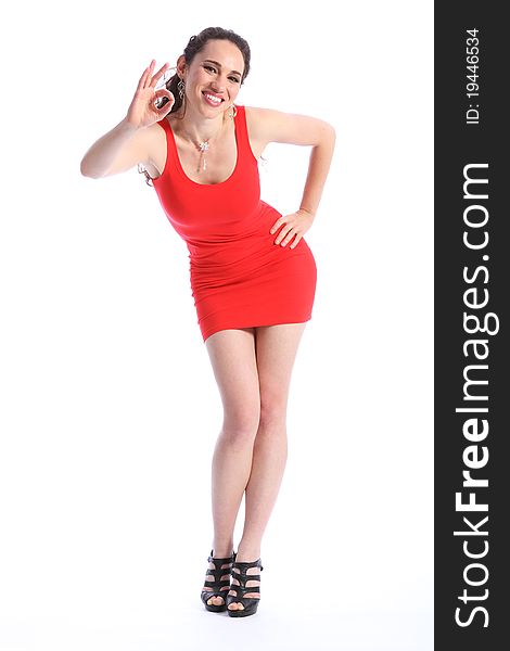 Ok hand sign from beautiful, female fashion model, wearing black high heel shoes and a short red dress. Full length against white background. Ok hand sign from beautiful, female fashion model, wearing black high heel shoes and a short red dress. Full length against white background.