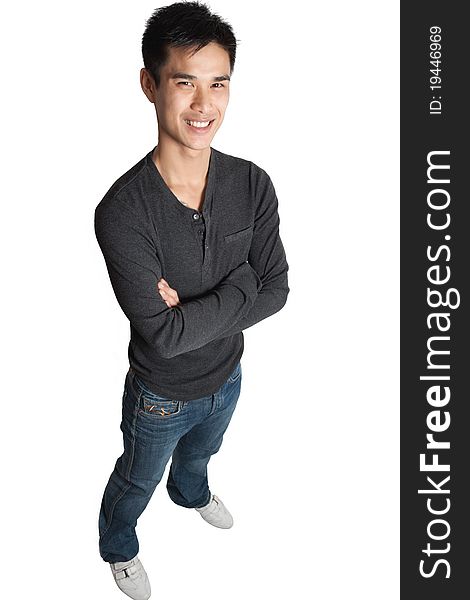 Young man standing with his arms crossed smiling at camera. Young man standing with his arms crossed smiling at camera