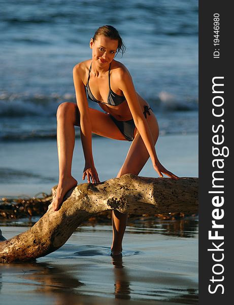 Fashion Model posing sexy at ocean golden sunset in Palos Verdes, Southern California, USA