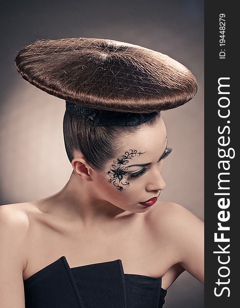 Portrait of beautiful girl with coiffure disc on grey. Portrait of beautiful girl with coiffure disc on grey
