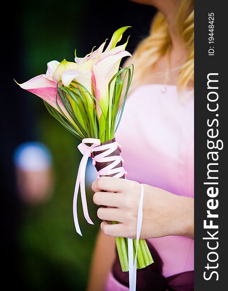 A bridesmaid holding her bouquet at a wedding