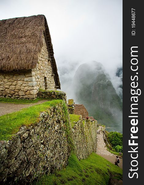 A cobble stone house on a mountain at Machu Picchu in Peru. A cobble stone house on a mountain at Machu Picchu in Peru