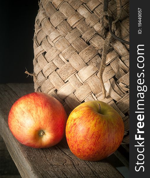 Still-life from apples and an old basket