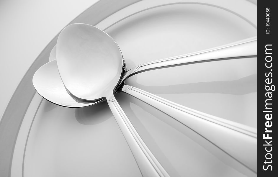 Three spoons lie on a plate. Three spoons lie on a plate