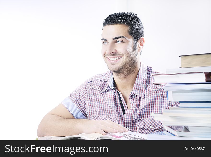 Young student smiling with books on white background, concept of successful