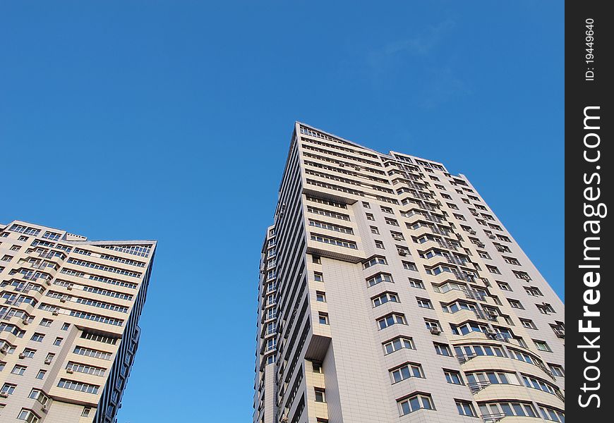 Two dwellings house in town on a background blue sky. Two dwellings house in town on a background blue sky