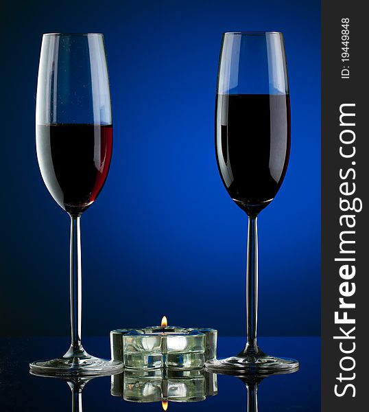 Glass of wine in studio on blue background