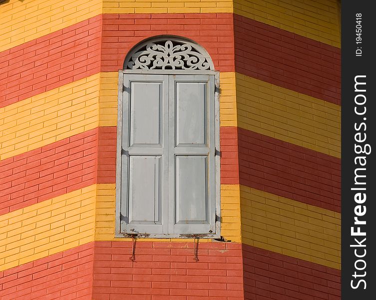 Old window on red and yellow brick wall at Bang Pa In Palace Ayutthaya province Thailand. Old window on red and yellow brick wall at Bang Pa In Palace Ayutthaya province Thailand