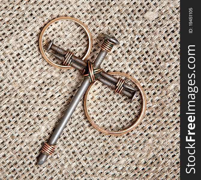 A cross with nails on canvas background