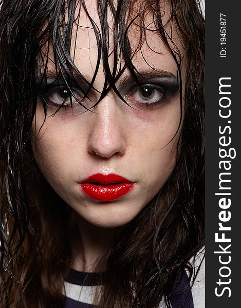 Close up portrait of beauty young girl with wet hairs and face with red glossy lipstick, bright makeup in studio. Close up portrait of beauty young girl with wet hairs and face with red glossy lipstick, bright makeup in studio