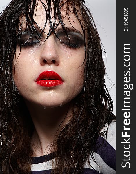 Close up portrait of beauty young girl with wet hairs and face with red glossy lipstick, bright makeup in studio. Close up portrait of beauty young girl with wet hairs and face with red glossy lipstick, bright makeup in studio