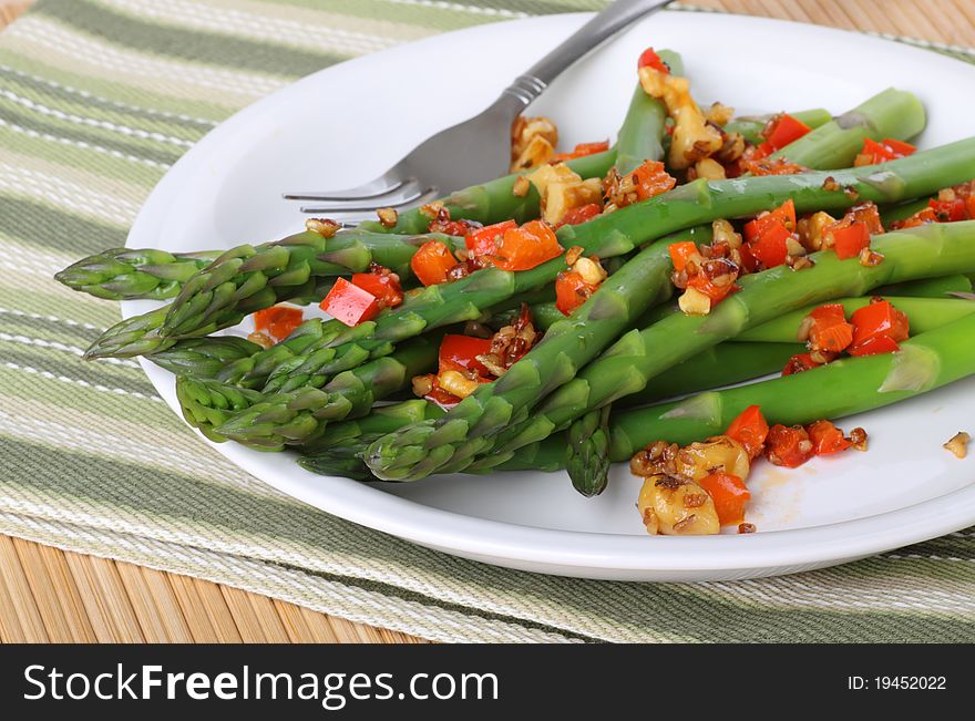 Asparagus with red peppers on a plate. Asparagus with red peppers on a plate