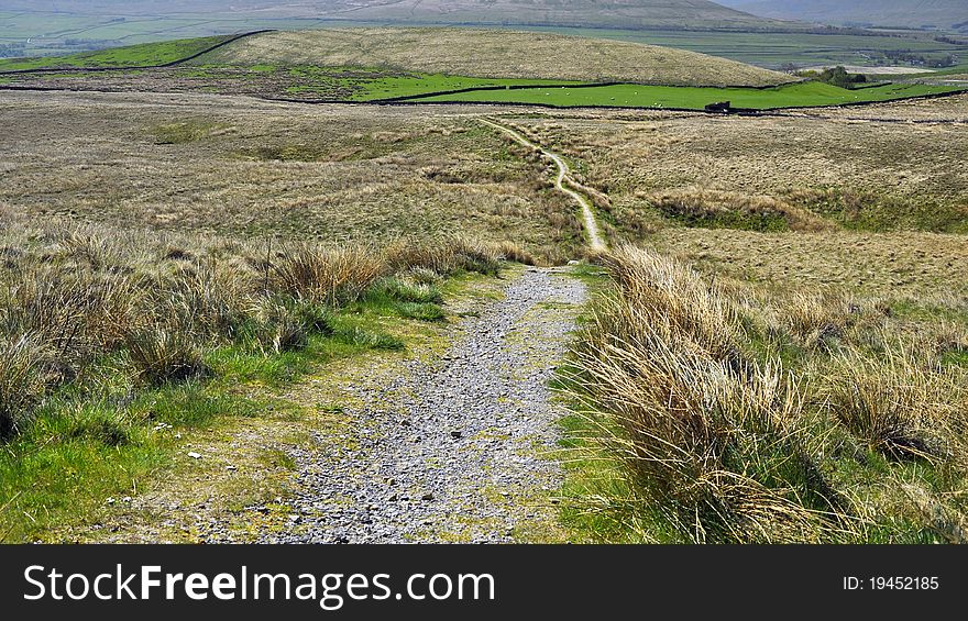 English hilly countryside: footpath, grassy fields