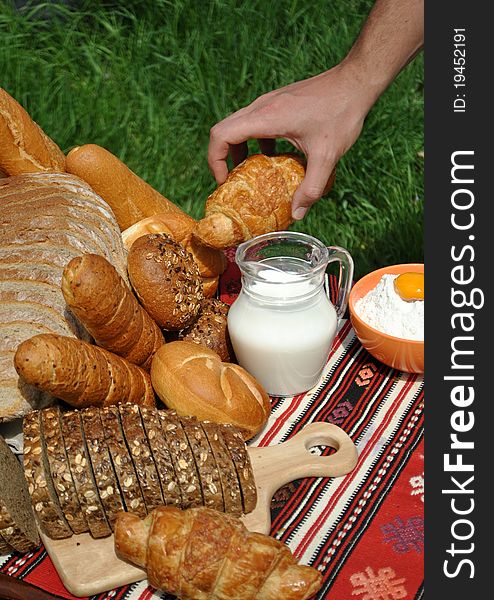 Image of tasty bakery products and hand reaching for a croissant. Image of tasty bakery products and hand reaching for a croissant