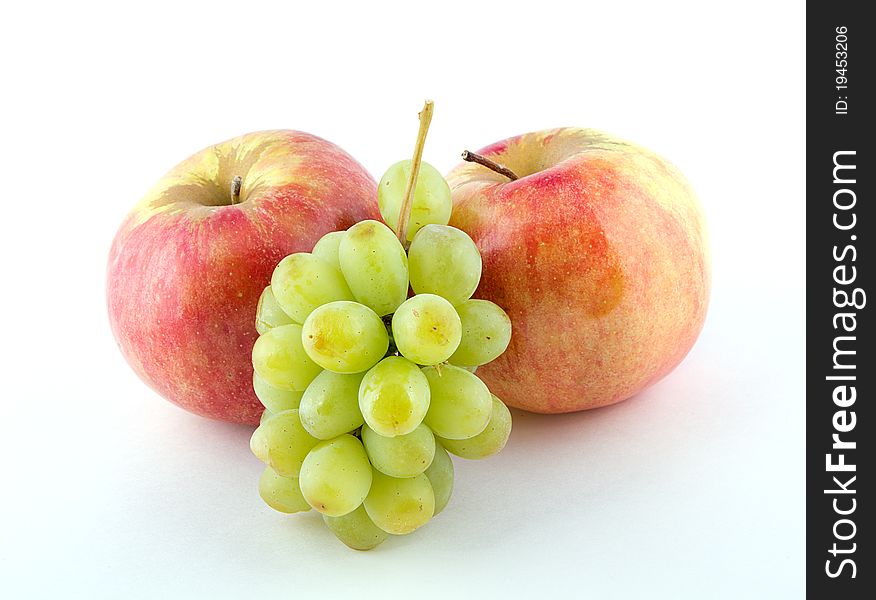 Two apples and green grapes on a white background. Two apples and green grapes on a white background.