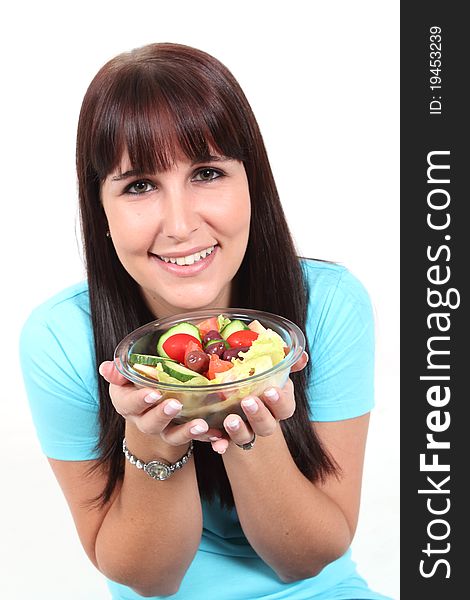 Woman holding a bowl with salad