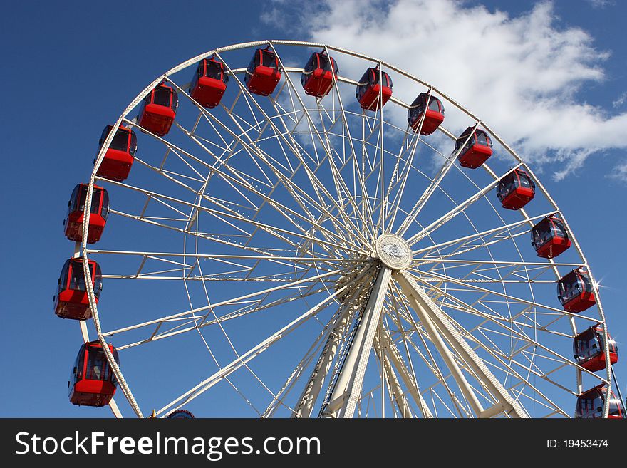 Red Carriages on a Large Fun Fair Big Wheel.