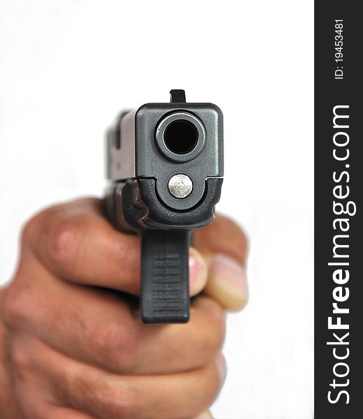 Pistol in a man's hand on a white background.
