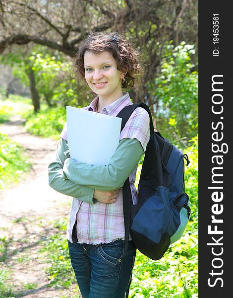 Female Teenage Student In Summer Park