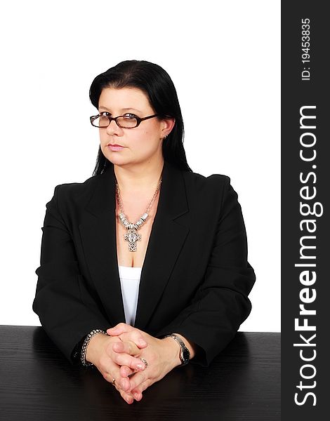 Business lady sitting a a desk with a stern look on her face
