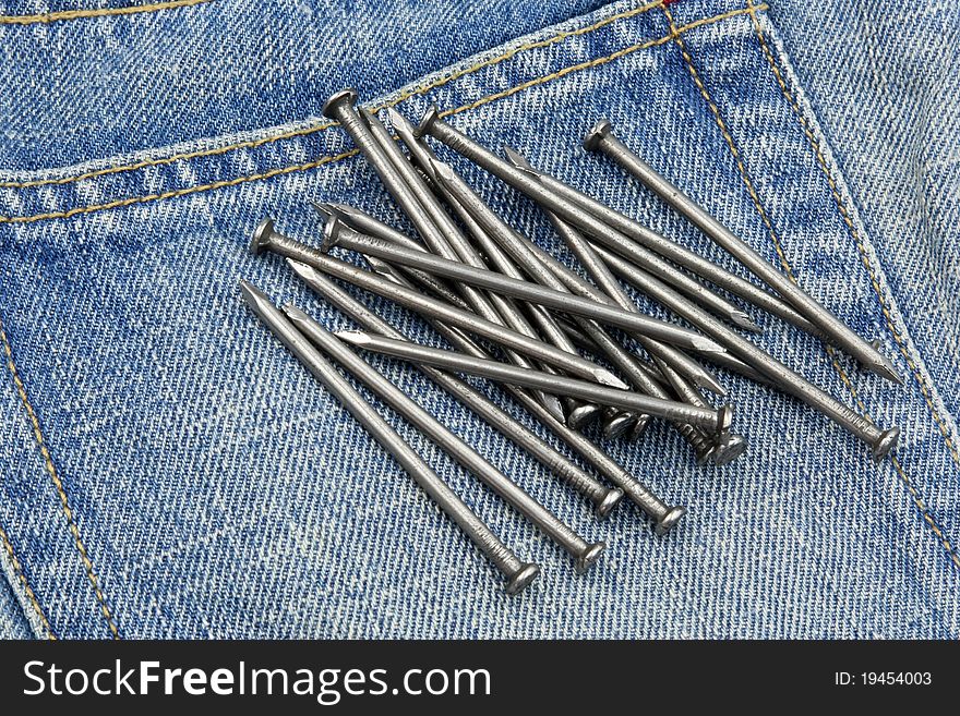 Nails on jeans in concept of carpenter