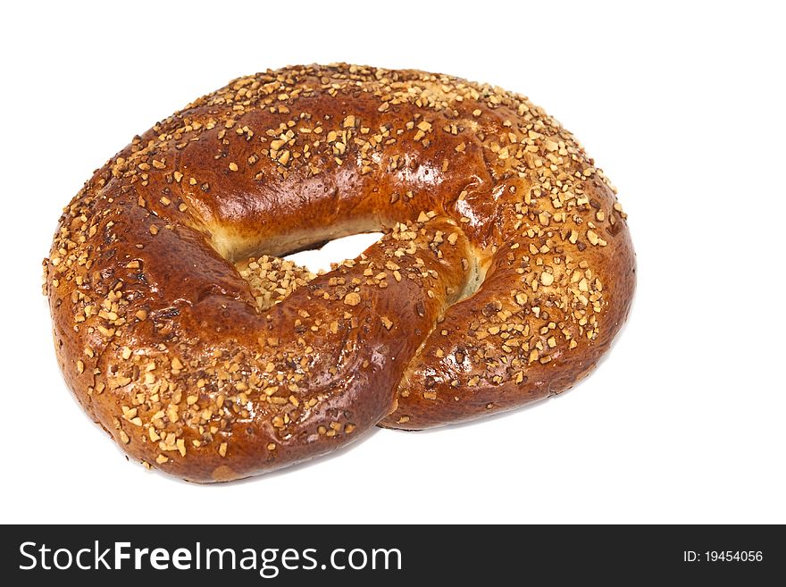 Pretzel, topped with crushed nuts on a white background. Pretzel, topped with crushed nuts on a white background.