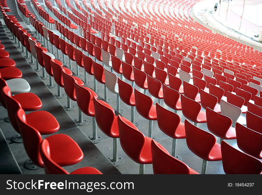 A red and white chair with number array in stadium. A red and white chair with number array in stadium.