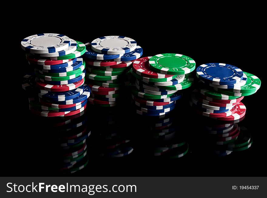 Many poker chips on a black background