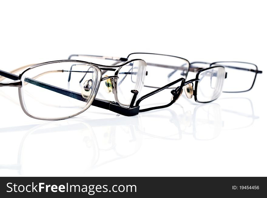 Broken black eyeglasses isolated on a white background