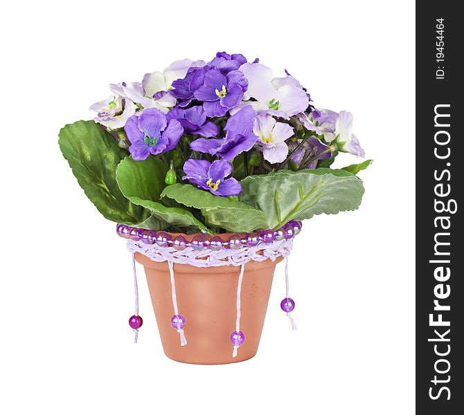 Artificial violet in ceramic pots, decorated with beads, handmade,  isolated on a white background.