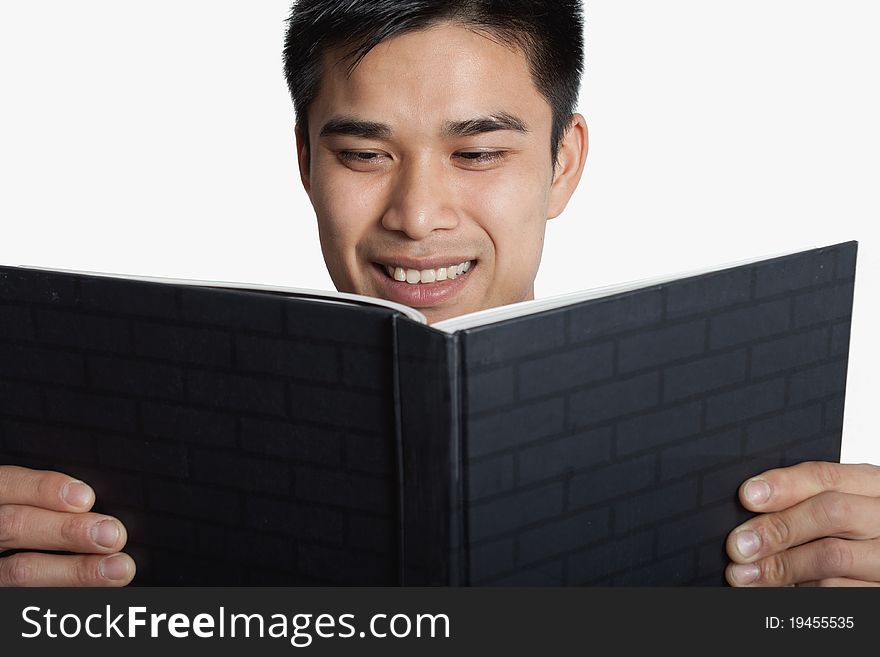 A man looking at a book on a white background. A man looking at a book on a white background