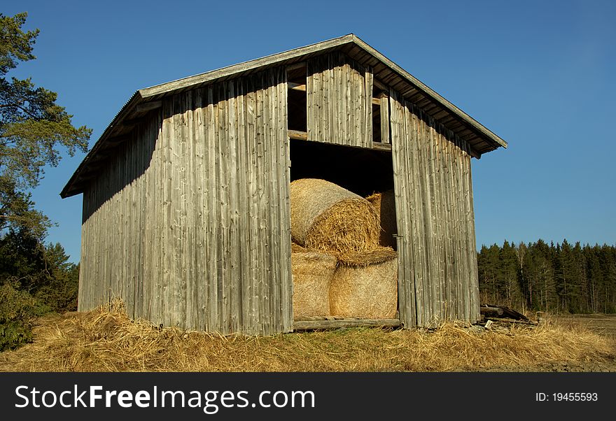 A finnish country barn with stacked hay in it. A finnish country barn with stacked hay in it.