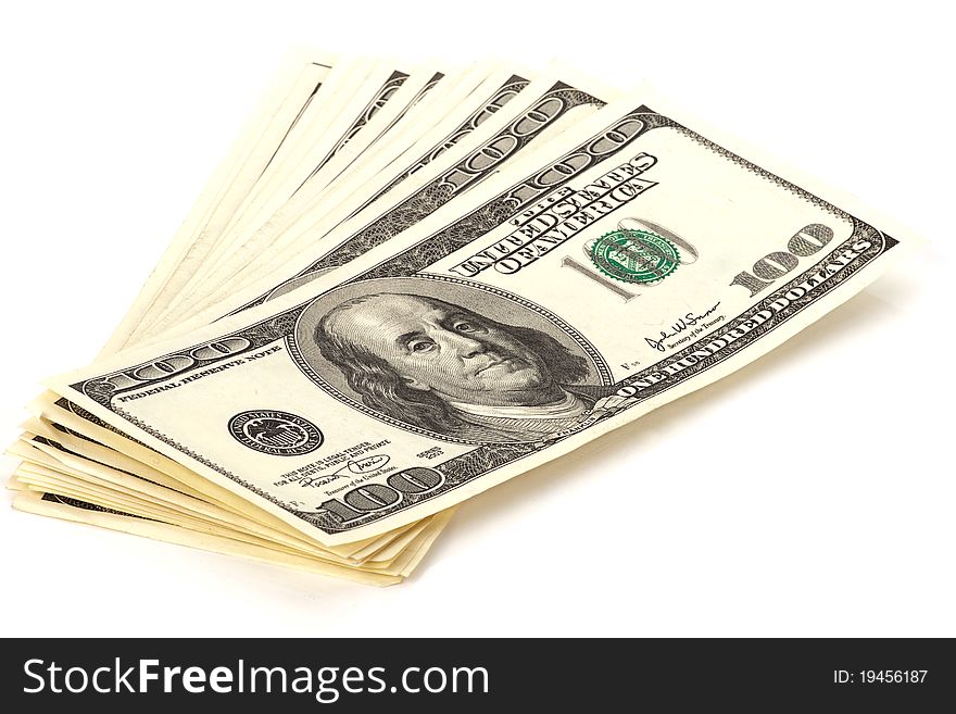 Heap of 100 dollars banknotes isolated over white
