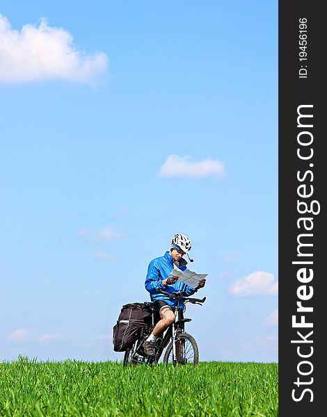 Mountain biker on sunny day with a map