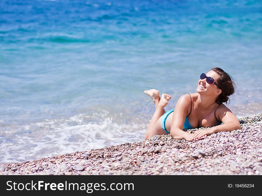 Smiley Young woman with sunglasses on a beach. Smiley Young woman with sunglasses on a beach