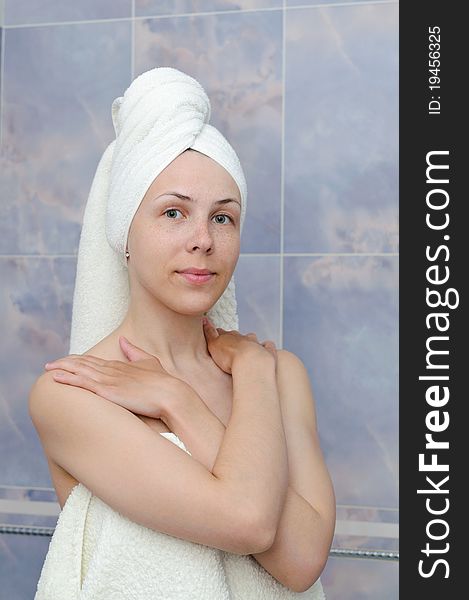 Young woman after bath in white towels