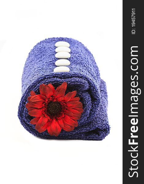 Beautiful decoration with blue towel and red flower isolated on white. Beautiful decoration with blue towel and red flower isolated on white