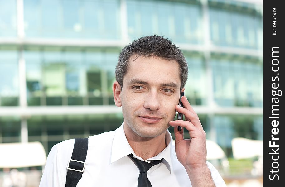 Manager speak on phone across office building